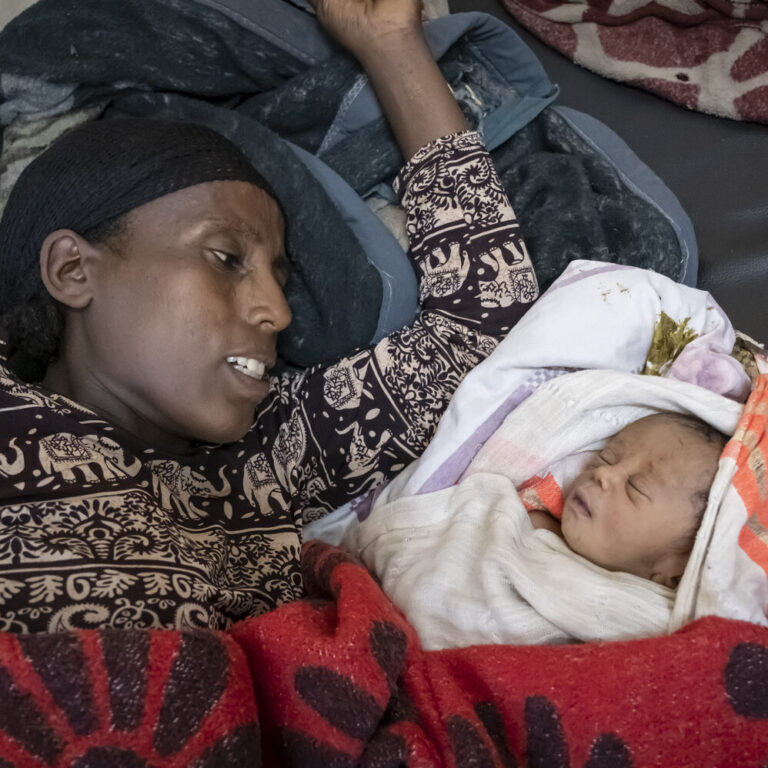Kasach Tadesee begutachtet ihren neugeborenen Sohn. Er schläft.